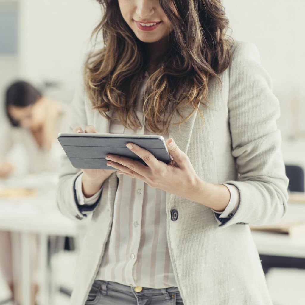 Businesswoman using tablet in office.