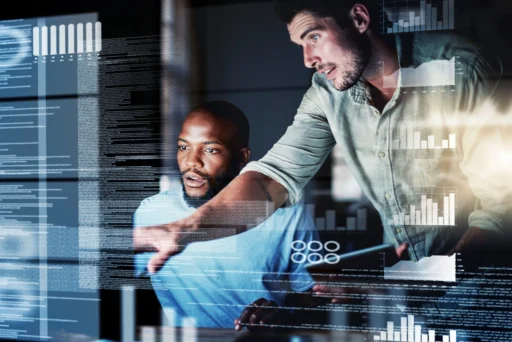 Two men sitting at a computer looking at Right Click Tools in action, part of Recast Software's endpoint management software solutions.