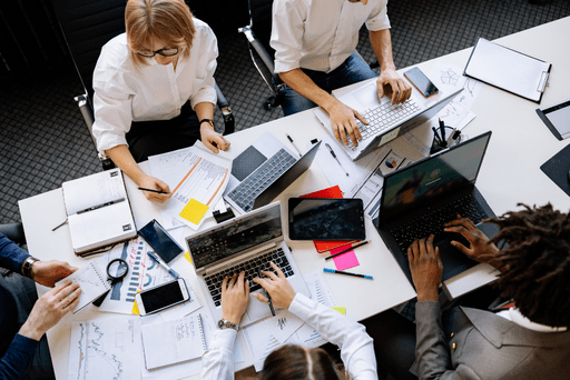 Image of staff working on several different devices.