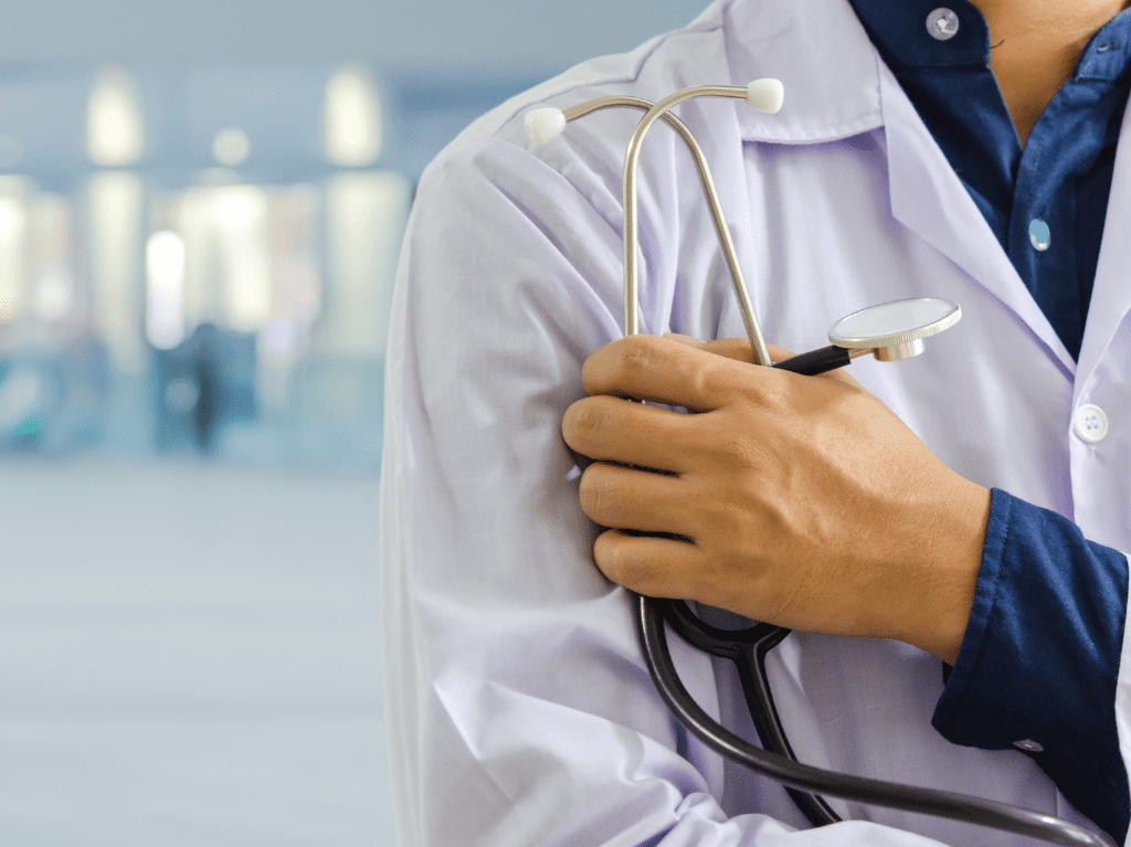 A medical professional holding their stethoscope.