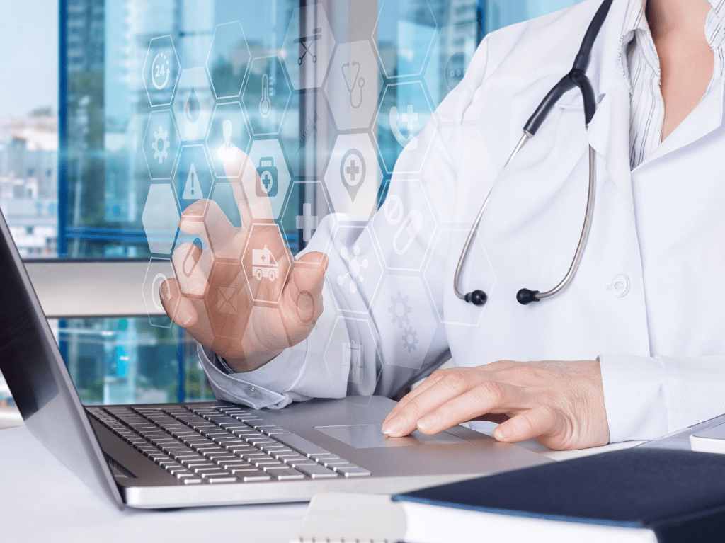 A medical professional using a laptop to help them with their daily work.