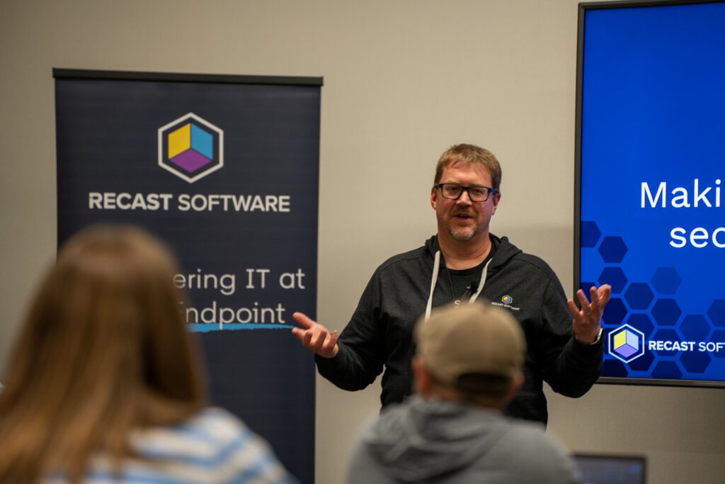 A Recast Software expert giving a presentation at an event.