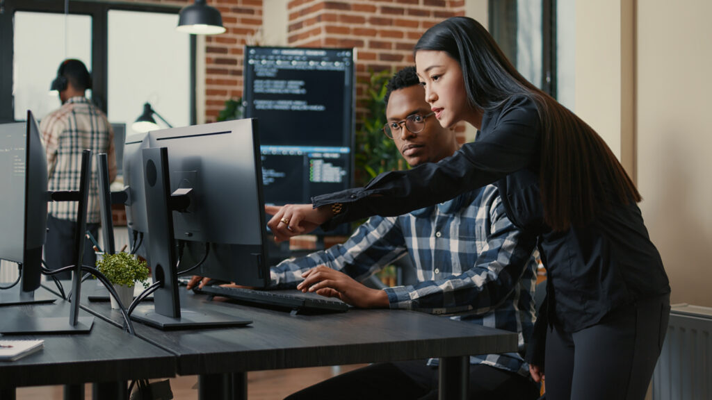 Man and woman looking at computer monitor
